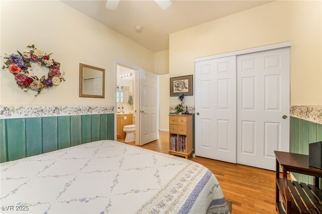 532 Kavanagh Pl, Las Vegas, NV 89123 - bedroom featuring light wood-type flooring, a closet, wainscoting, ensuite bath, and ceiling fan