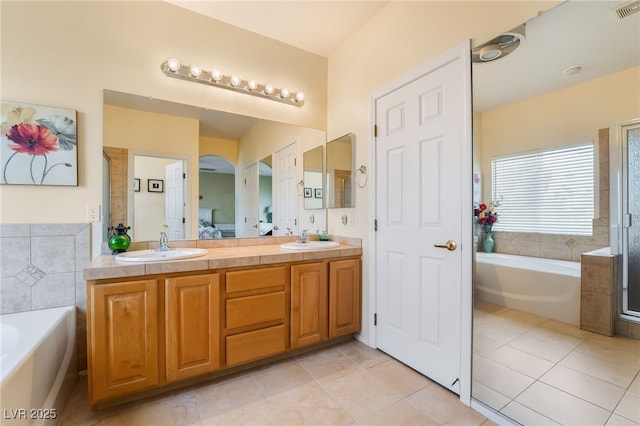 532 Kavanagh Pl, Las Vegas, NV 89123 - full bathroom featuring a bath, double vanity, tile patterned floors, and a shower with shower door