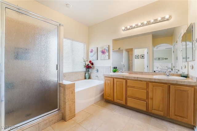 532 Kavanagh Pl, Las Vegas, NV 89123 - full bathroom with a shower stall, a bath, double vanity, tile patterned floors, and ensuite bathroom
