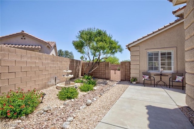 7816 Glowing Peak St, Las Vegas, NV 89131 - fenced backyard with a patio and a gate