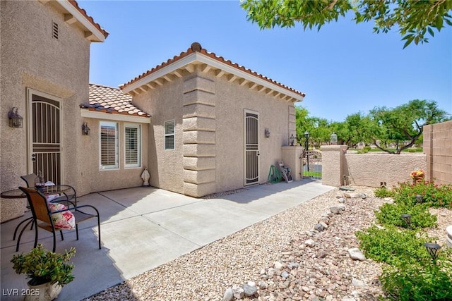 7816 Glowing Peak St, Las Vegas, NV 89131 - rear view of property with a tile roof, stucco siding, and a patio area