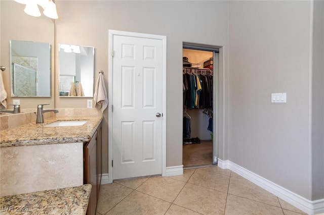 7816 Glowing Peak St, Las Vegas, NV 89131 - full bathroom with vanity, tile patterned flooring, a shower stall, and a walk in closet