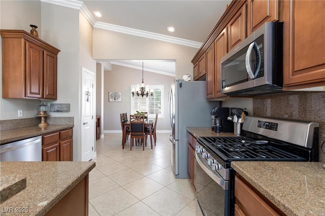 7816 Glowing Peak St, Las Vegas, NV 89131 - kitchen featuring stainless steel appliances, crown molding, brown cabinets, a chandelier, and light tile patterned floors