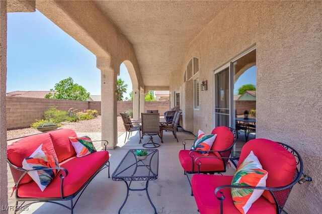 7816 Glowing Peak St, Las Vegas, NV 89131 - fenced backyard featuring outdoor dining space, a patio, and an outdoor living space