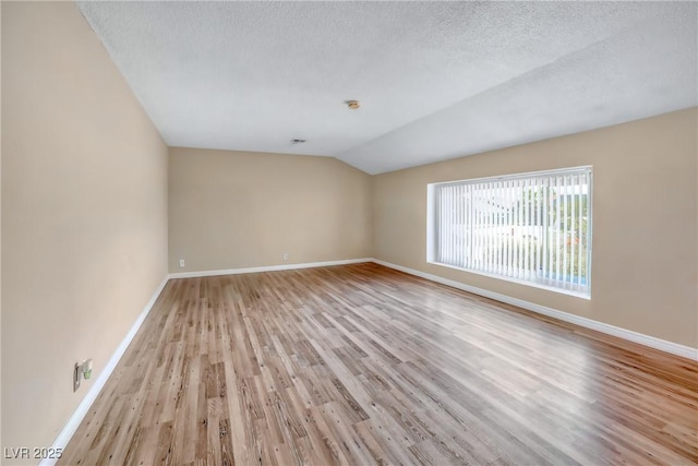 2009 E Oakey Blvd, Las Vegas, NV 89104 - empty room featuring wood finished floors, lofted ceiling, and a textured ceiling