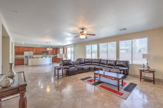 4016 Gaster Ave, North Las Vegas, NV 89081 - living area featuring ceiling fan, light tile patterned floors, and a chandelier
