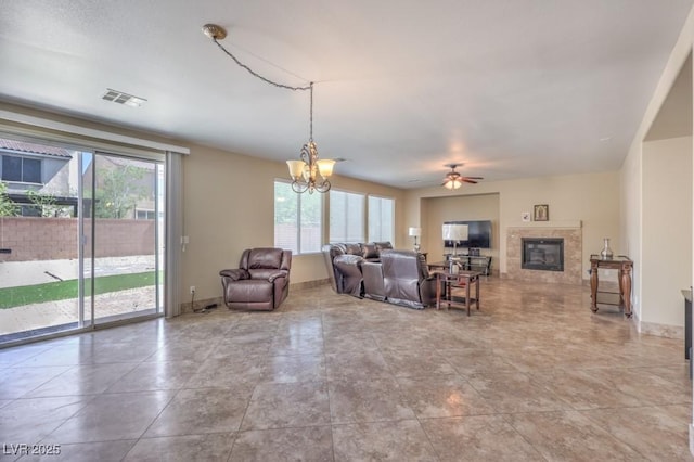 4016 Gaster Ave, North Las Vegas, NV 89081 - living area featuring plenty of natural light, a glass covered fireplace, ceiling fan, and a chandelier