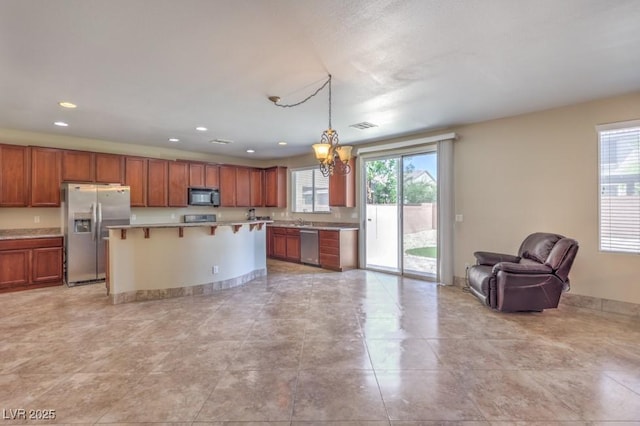 4016 Gaster Ave, North Las Vegas, NV 89081 - kitchen with stainless steel appliances, healthy amount of natural light, a chandelier, open floor plan, and recessed lighting