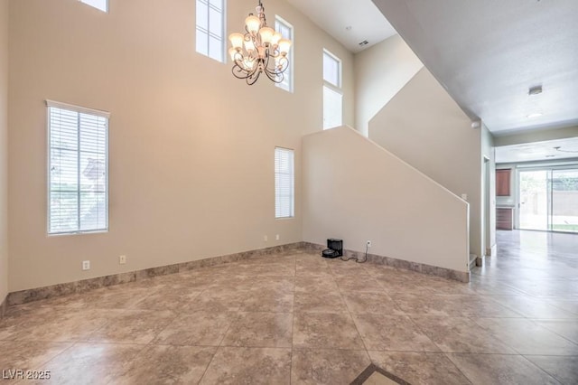 4016 Gaster Ave, North Las Vegas, NV 89081 - unfurnished living room featuring a chandelier, a high ceiling, and stairway
