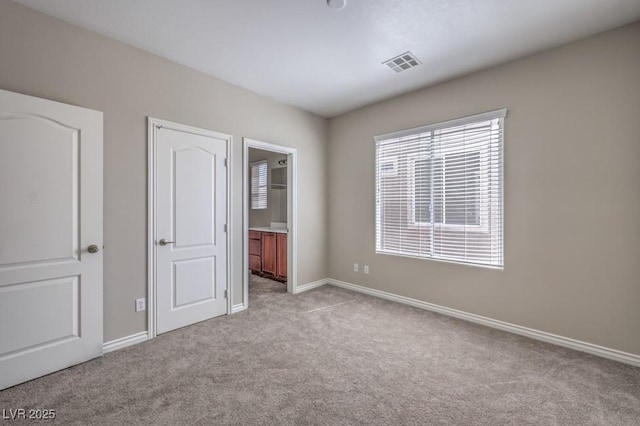 4016 Gaster Ave, North Las Vegas, NV 89081 - unfurnished bedroom with light carpet and ensuite bathroom