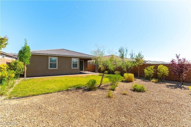 10711 Silver Pond Ave, Las Vegas, NV 89135 - rear view of property with a fenced backyard and stucco siding