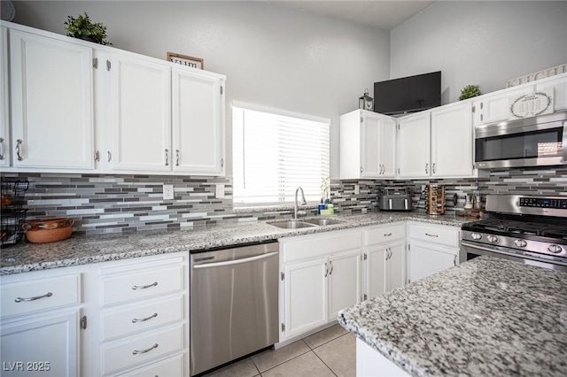 1553 Bright View Dr, Las Vegas, NV 89119 - kitchen featuring stainless steel appliances, backsplash, white cabinets, and light tile patterned floors