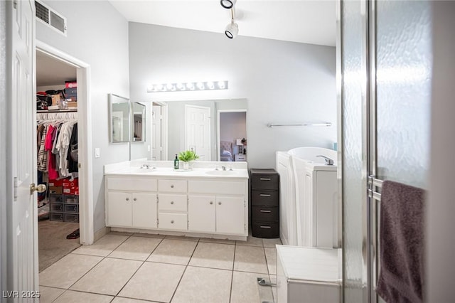 1553 Bright View Dr, Las Vegas, NV 89119 - bathroom featuring double vanity, tile patterned floors, and a spacious closet