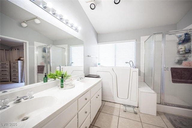 1553 Bright View Dr, Las Vegas, NV 89119 - full bathroom with a shower stall, double vanity, a bath, tile patterned flooring, and vaulted ceiling