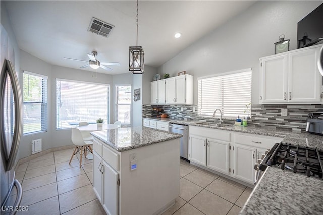1553 Bright View Dr, Las Vegas, NV 89119 - kitchen featuring stainless steel appliances, backsplash, plenty of natural light, a center island, and recessed lighting