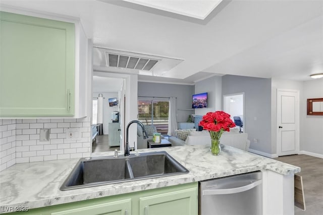 7100 Pirates Cove Rd Unit 2076, Las Vegas, NV 89145 - kitchen featuring stainless steel dishwasher, decorative backsplash, green cabinetry, and a peninsula