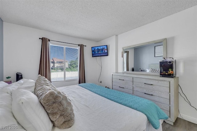 7100 Pirates Cove Rd Unit 2076, Las Vegas, NV 89145 - bedroom featuring wood finished floors and a textured ceiling