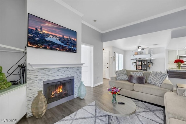 7100 Pirates Cove Rd Unit 2076, Las Vegas, NV 89145 - living area featuring wood finished floors, a tiled fireplace, ornamental molding, and a ceiling fan