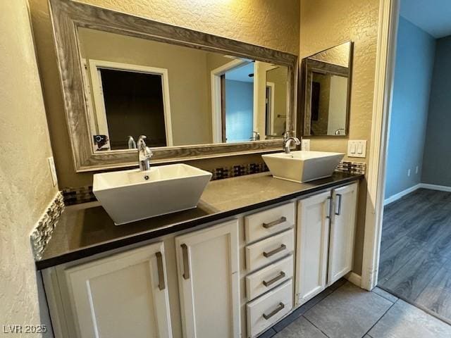 2704 Willow Wren Dr, North Las Vegas, NV 89084 - bathroom with a textured wall, double vanity, and tile patterned floors