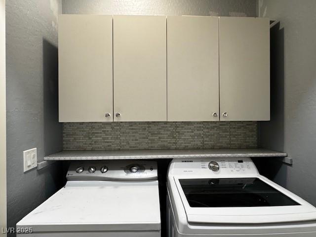 2704 Willow Wren Dr, North Las Vegas, NV 89084 - washroom with cabinet space, a textured wall, and washer and clothes dryer
