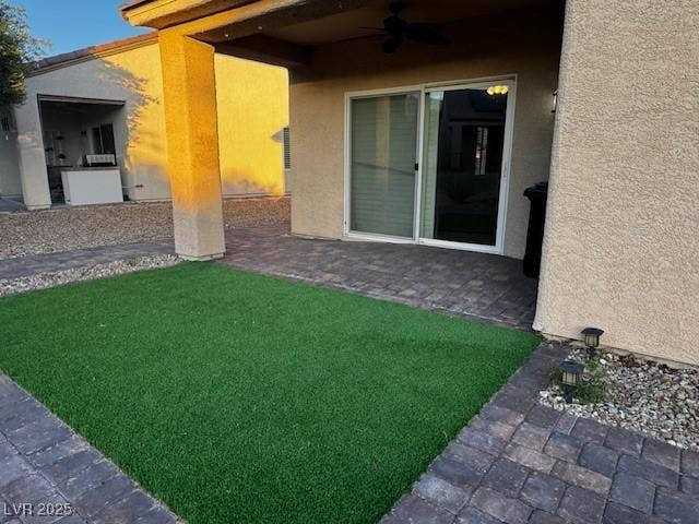 2704 Willow Wren Dr, North Las Vegas, NV 89084 - view of green lawn with ceiling fan and a patio