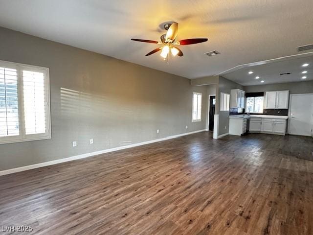 2704 Willow Wren Dr, North Las Vegas, NV 89084 - unfurnished living room featuring dark wood-style flooring, a ceiling fan, and recessed lighting