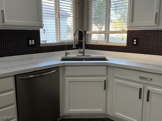 2704 Willow Wren Dr, North Las Vegas, NV 89084 - kitchen featuring dishwasher, white cabinetry, backsplash, and healthy amount of natural light