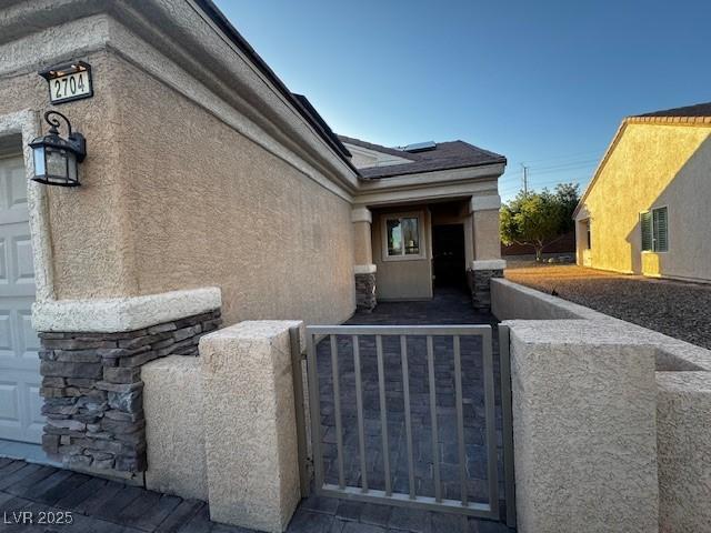 2704 Willow Wren Dr, North Las Vegas, NV 89084 - view of side of property with stucco siding and stone siding
