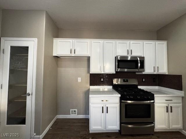 2704 Willow Wren Dr, North Las Vegas, NV 89084 - kitchen featuring stainless steel appliances, white cabinetry, and dark wood finished floors
