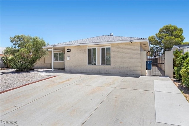 321 Oil Lantern Ln, Las Vegas, NV 89145 - rear view of property with a gate, brick siding, and a patio area
