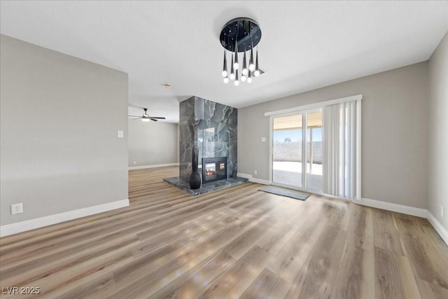 321 Oil Lantern Ln, Las Vegas, NV 89145 - unfurnished living room featuring wood finished floors, ceiling fan, and a high end fireplace