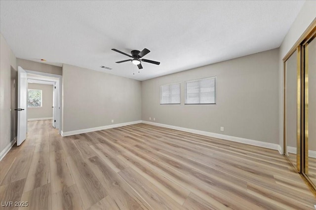 321 Oil Lantern Ln, Las Vegas, NV 89145 - unfurnished bedroom featuring a closet, light wood finished floors, ceiling fan, and a textured ceiling
