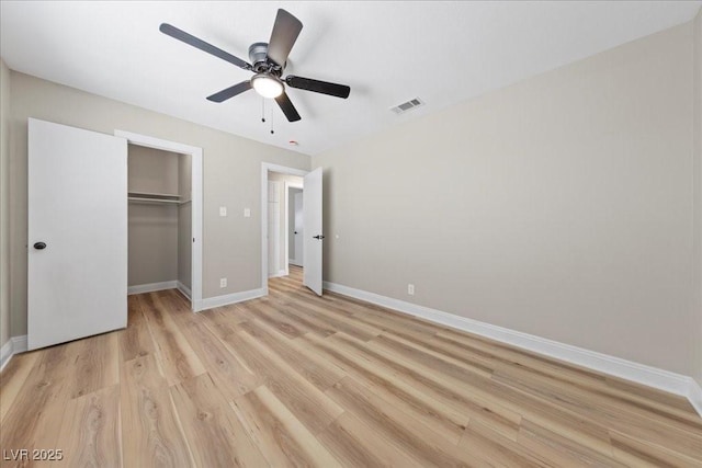 321 Oil Lantern Ln, Las Vegas, NV 89145 - unfurnished bedroom with light wood-style floors, a spacious closet, a closet, and a ceiling fan