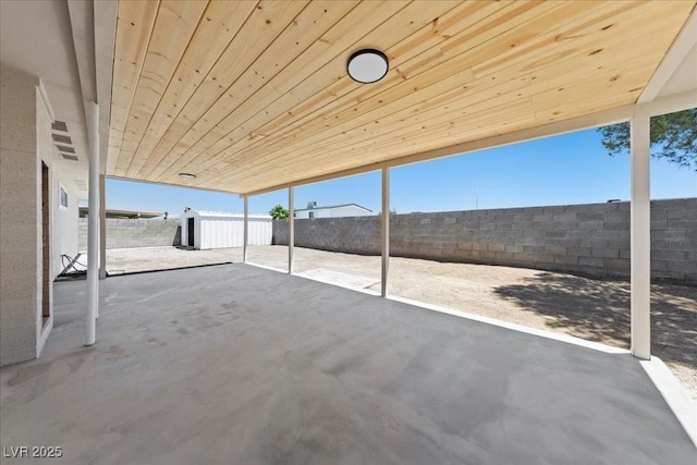 321 Oil Lantern Ln, Las Vegas, NV 89145 - fenced backyard featuring a patio and an outbuilding