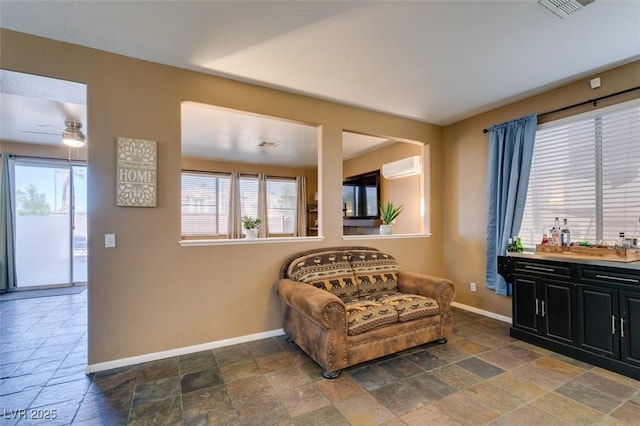 4512 Long Horse Ct, Las Vegas, NV 89147 - sitting room featuring stone tile floors, an AC wall unit, and a ceiling fan