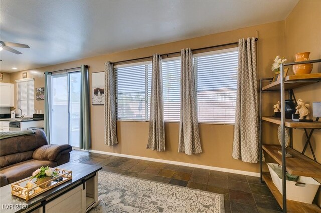4512 Long Horse Ct, Las Vegas, NV 89147 - living room featuring a ceiling fan and dark stone finish flooring