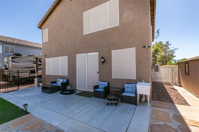 4512 Long Horse Ct, Las Vegas, NV 89147 - back of property with a patio area, a fenced backyard, stucco siding, an outdoor living space, and a gate