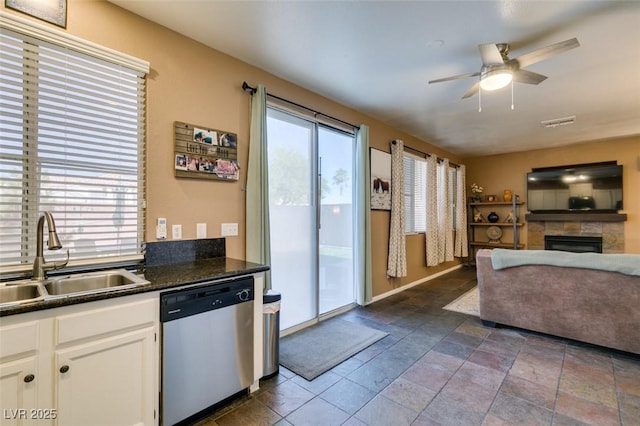 4512 Long Horse Ct, Las Vegas, NV 89147 - living area featuring a ceiling fan, a stone fireplace, and stone tile floors