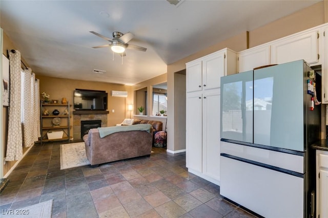 4512 Long Horse Ct, Las Vegas, NV 89147 - living room with ceiling fan, a fireplace, and stone tile flooring