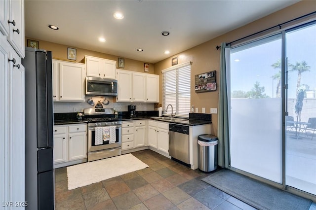 4512 Long Horse Ct, Las Vegas, NV 89147 - kitchen with appliances with stainless steel finishes, dark countertops, backsplash, recessed lighting, and white cabinetry