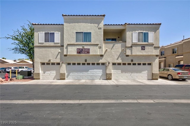 6170 E Sahara Ave Unit 1076, Las Vegas, NV 89142 - view of front facade with an attached garage, stucco siding, and a tiled roof