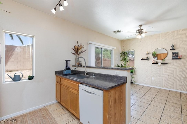 6170 E Sahara Ave Unit 1076, Las Vegas, NV 89142 - kitchen with dishwasher, a peninsula, dark countertops, ceiling fan, and light tile patterned flooring