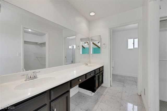 1385 Morning Sun Way, Las Vegas, NV 89110 - full bath featuring double vanity, a walk in closet, marble look tiles, and recessed lighting