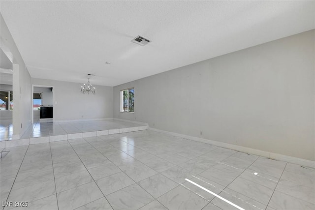 1385 Morning Sun Way, Las Vegas, NV 89110 - empty room with a chandelier and light marble finish flooring