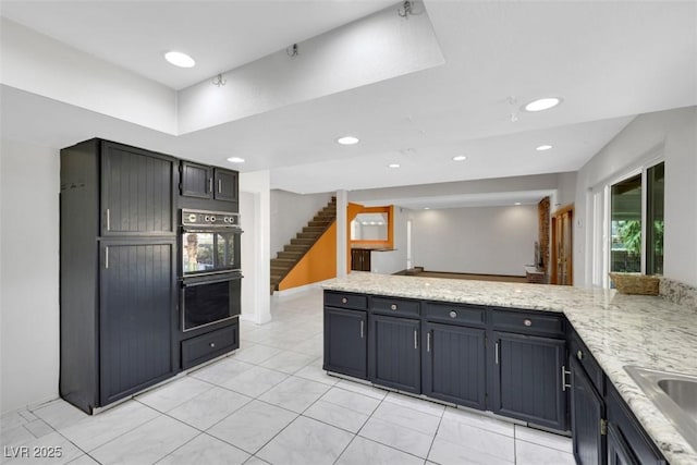 1385 Morning Sun Way, Las Vegas, NV 89110 - kitchen with recessed lighting, light tile patterned floors, a peninsula, and light stone countertops