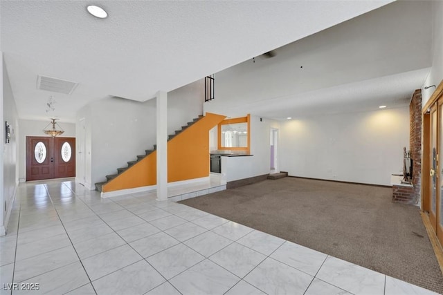 1385 Morning Sun Way, Las Vegas, NV 89110 - unfurnished living room with stairs, light carpet, light tile patterned floors, recessed lighting, and healthy amount of natural light