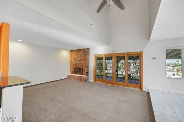 1385 Morning Sun Way, Las Vegas, NV 89110 - unfurnished living room featuring ceiling fan, healthy amount of natural light, a fireplace, carpet, and a high ceiling