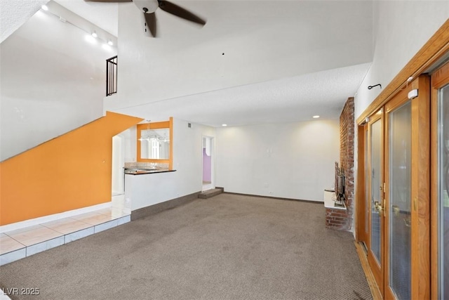 1385 Morning Sun Way, Las Vegas, NV 89110 - unfurnished living room with ceiling fan, carpet floors, rail lighting, recessed lighting, and tile patterned floors