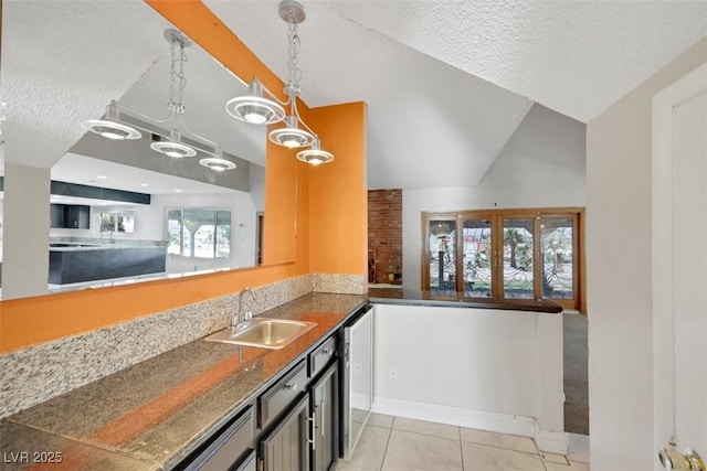 1385 Morning Sun Way, Las Vegas, NV 89110 - kitchen featuring a textured ceiling, light tile patterned flooring, decorative light fixtures, and lofted ceiling