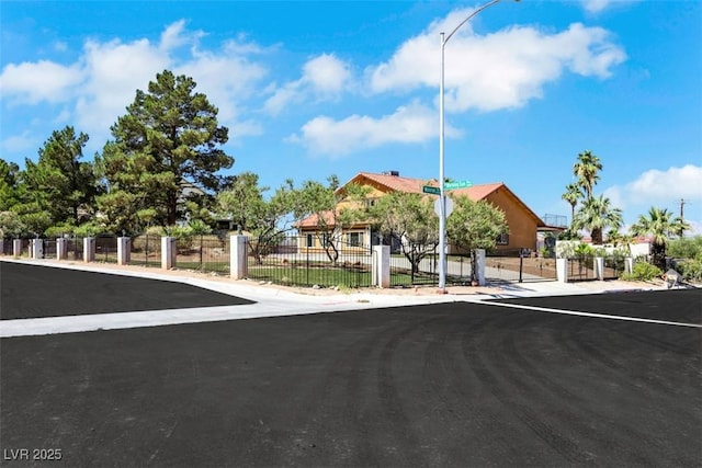 1385 Morning Sun Way, Las Vegas, NV 89110 - view of asphalt road featuring street lighting, a gate, and sidewalks